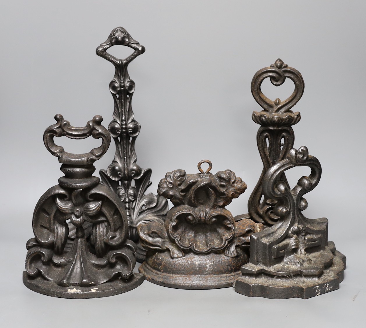 Five decorative cast iron door stops, tallest 35 cms high